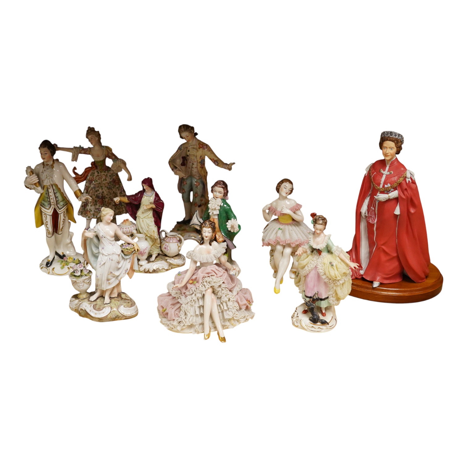 Nine continental figurines, to include Dresden porcelain lace examples, together with a resin figurine of Queen Elizabeth, largest 23cm high